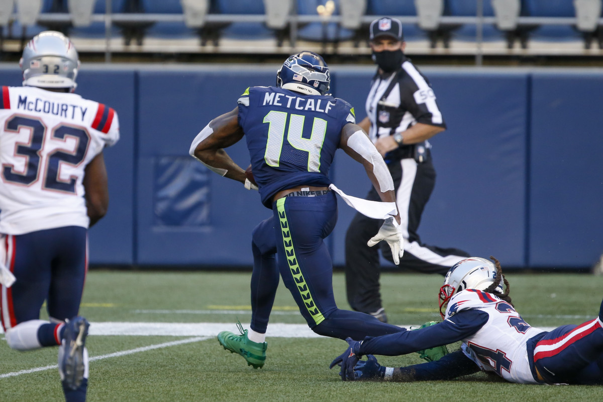 NFL: New England Patriots at Seattle Seahawks Sep 20, 2020; Seattle, Washington, USA; Seattle Seahawks wide receiver DK Metcalf (14) breaks a tackle against the New England Patriots for a touchdown catch during the second quarter at CenturyLink Field.