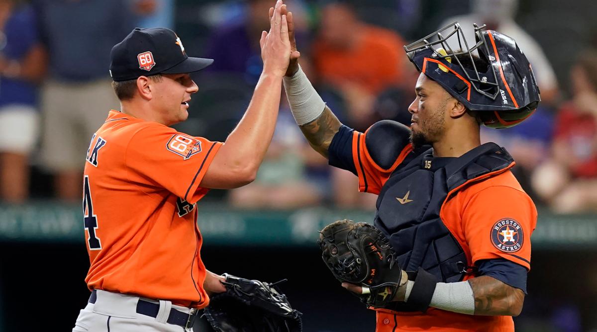 Houston Astros closer Brandon Bielak celebrates the win with teammate catcher Martin Maldonado after the final out of a baseball game against the Texas Rangers in Arlington, Texas, Wednesday, June 15, 2022. The Astros won 9-2.