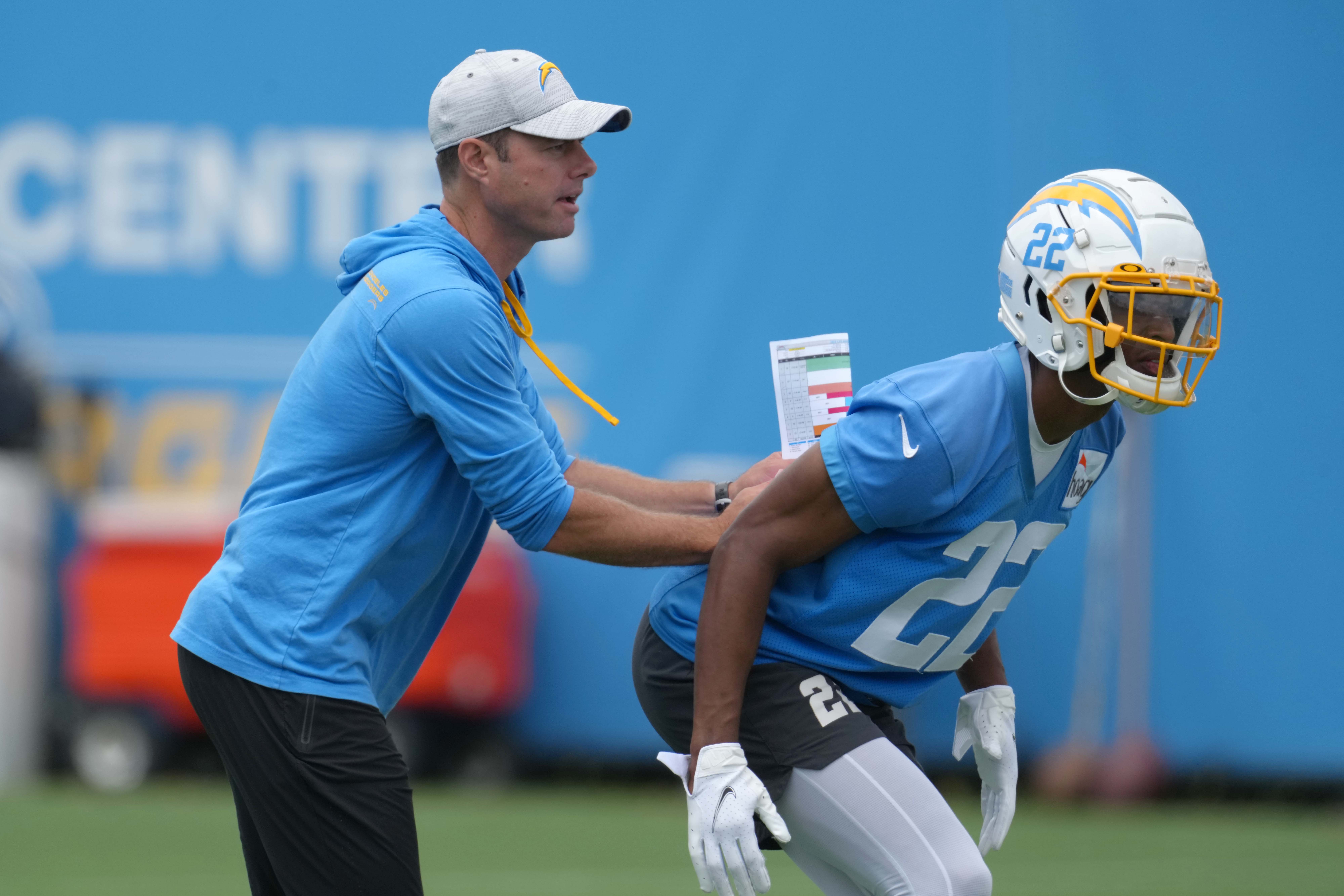 Jun 14, 2022; Costa Mesa, California, USA; Los Angeles Chargers coach Brandon Staley (left) and safety JT Woods (22) during minicamp at the Hoag Performance Center. Mandatory Credit: Kirby Lee-USA TODAY Sports