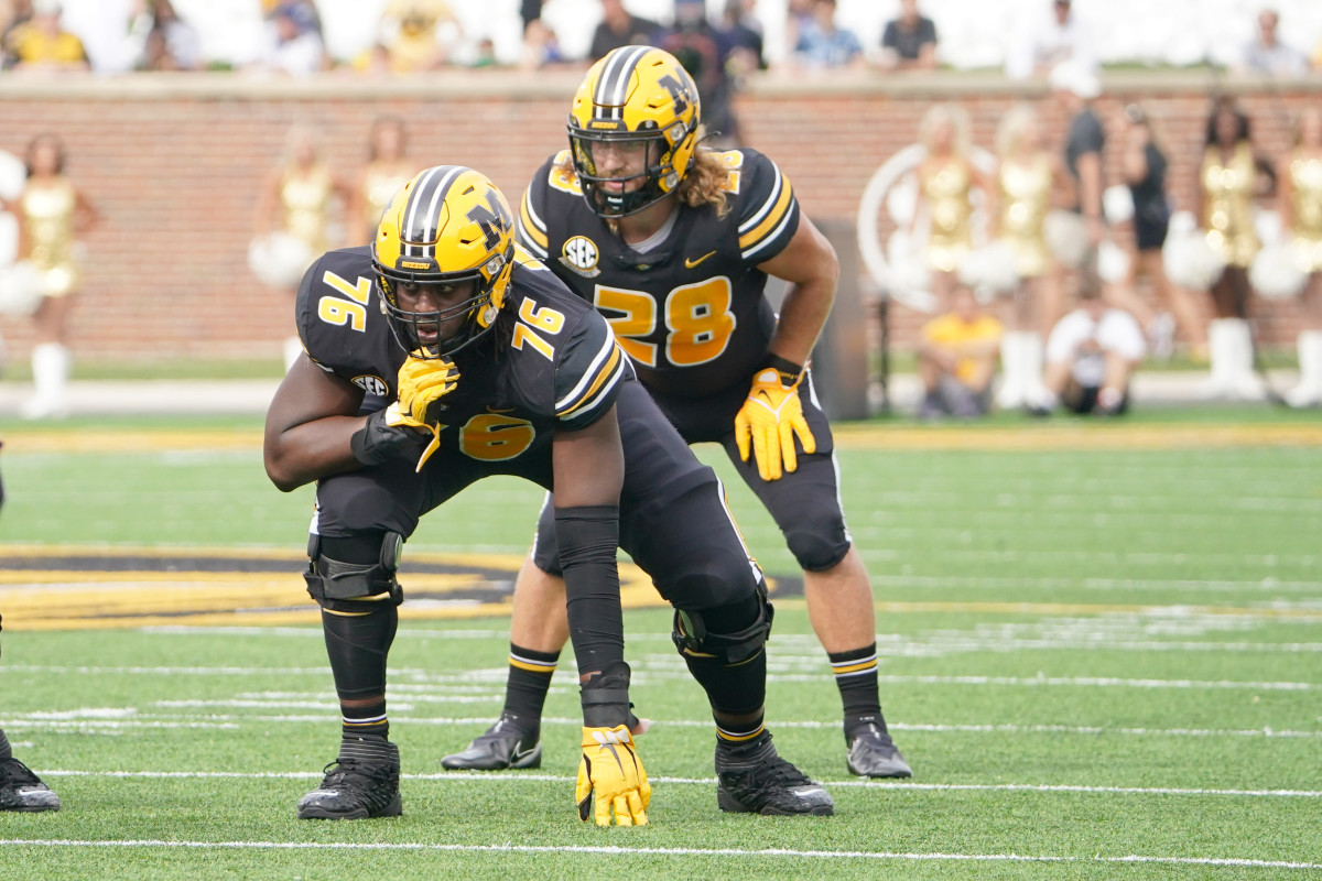Oct 9, 2021; Columbia, Missouri, USA; Missouri Tigers offensive lineman Javon Foster (76) and running back Dawson Downing (28) on the line of scrimmage against the North Texas Mean Green during the game at Faurot Field at Memorial Stadium. Mandatory Credit: Denny Medley-USA TODAY Sports