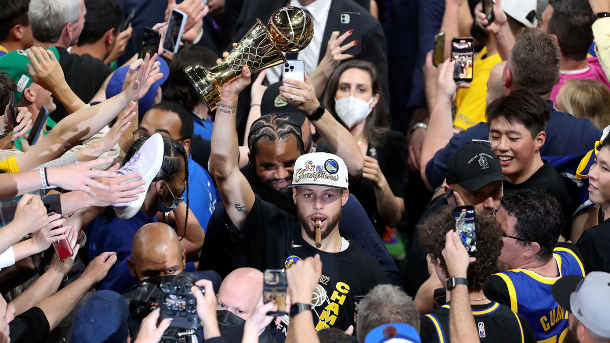 Golden State Warriors guard Stephen Curry (30) holds up the Most Valuable Player Trophy after defeating the Boston Celtics in game six in the 2022 NBA Finals.