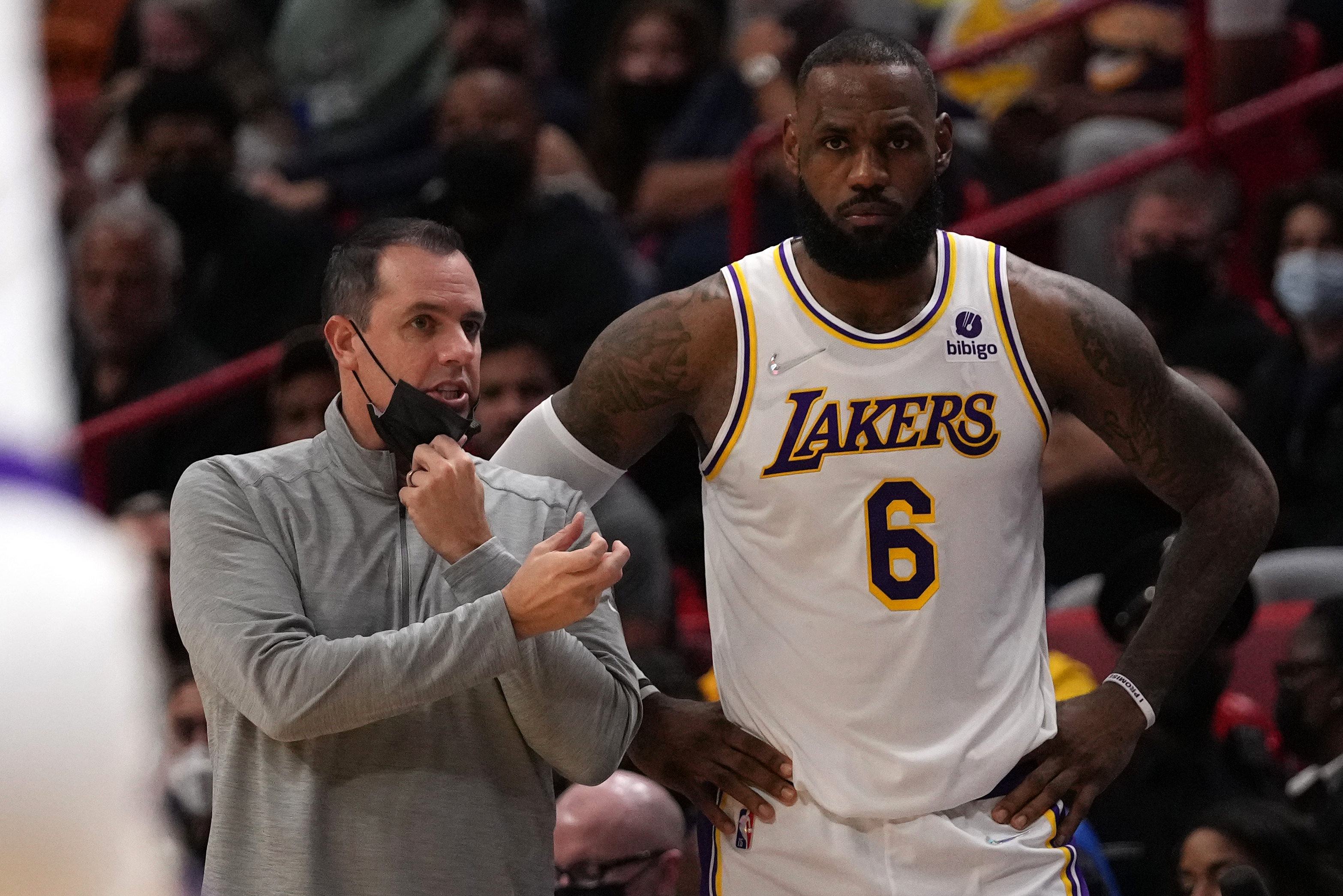 Los Angeles Lakers forward LeBron James (6) stands with head coach Frank Vogel (L) during the first half against the Miami Heat at FTX Arena.