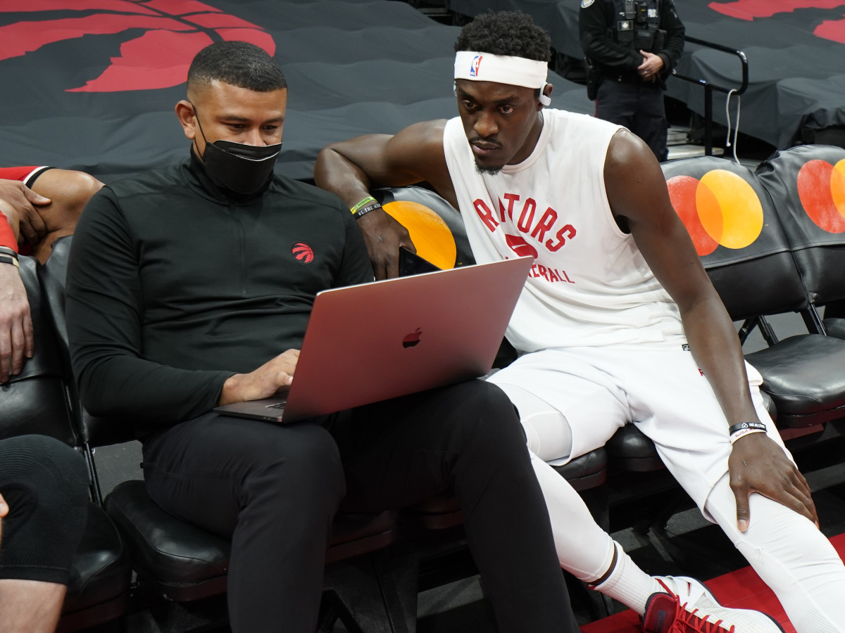 Toronto Raptors forward Pascal Siakam (right) reviews a play with assistant coach Earl Watson before a game against the Chicago Bulls at Scotiabank Arena.