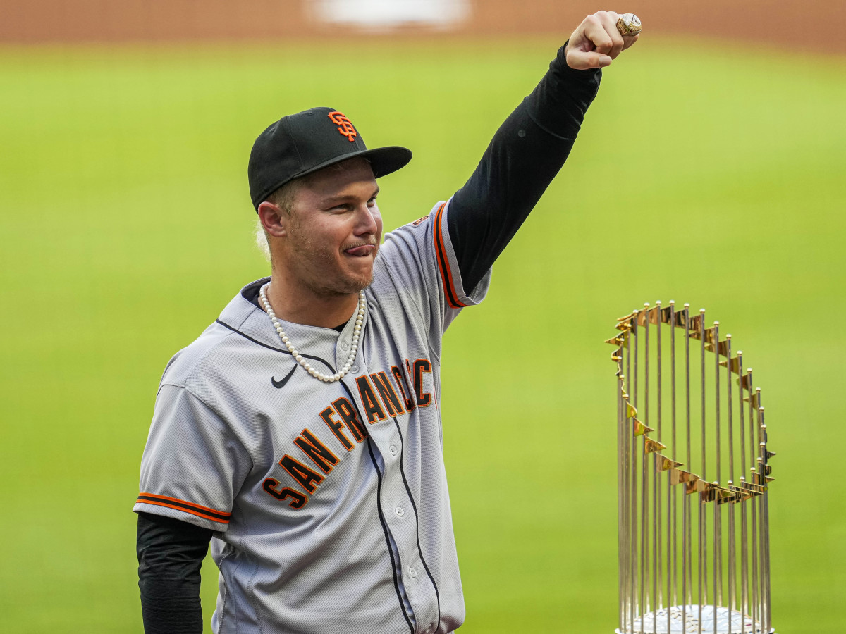 Jun 20, 2022; Cumberland, Georgia, USA; San Francisco Giants left fielder Joc Pederson (23) displays his World Series ring next to the Atlanta Braves 2021 World Series trophy after a ceremony before the game at Truist Park.