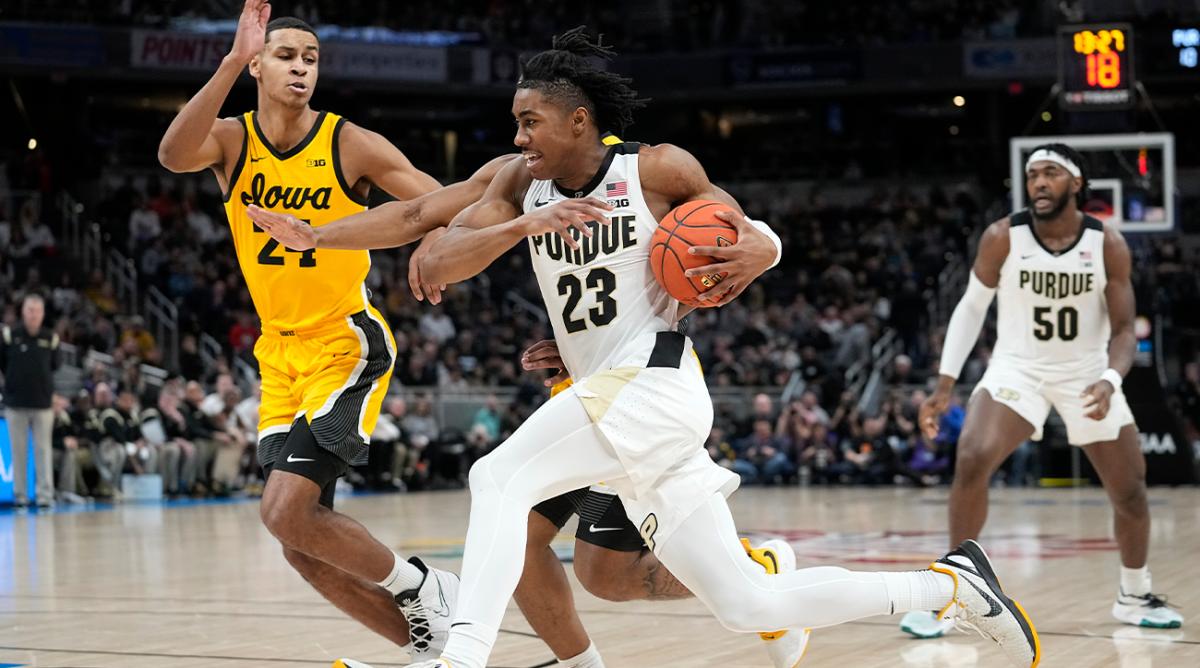 FILE - Purdue guard Jaden Ivey (23) drives to the basket next to Iowa forward Kris Murray (24) during the first half of an NCAA college basketball game at the Big Ten tournament March 13, 2022, in Indianapolis. Ivey is the headliner among point guard prospects in next week’s NBA draft.