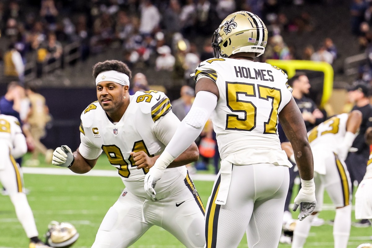 Dec 2, 2021; New Orleans, Louisiana, USA; New Orleans Saints defensive end Cameron Jordan (94) shares a moment with defensive end Jalyn Holmes (57) during warm ups before the game between the New Orleans Saints and the Dallas Cowboys at Caesars Superdome.