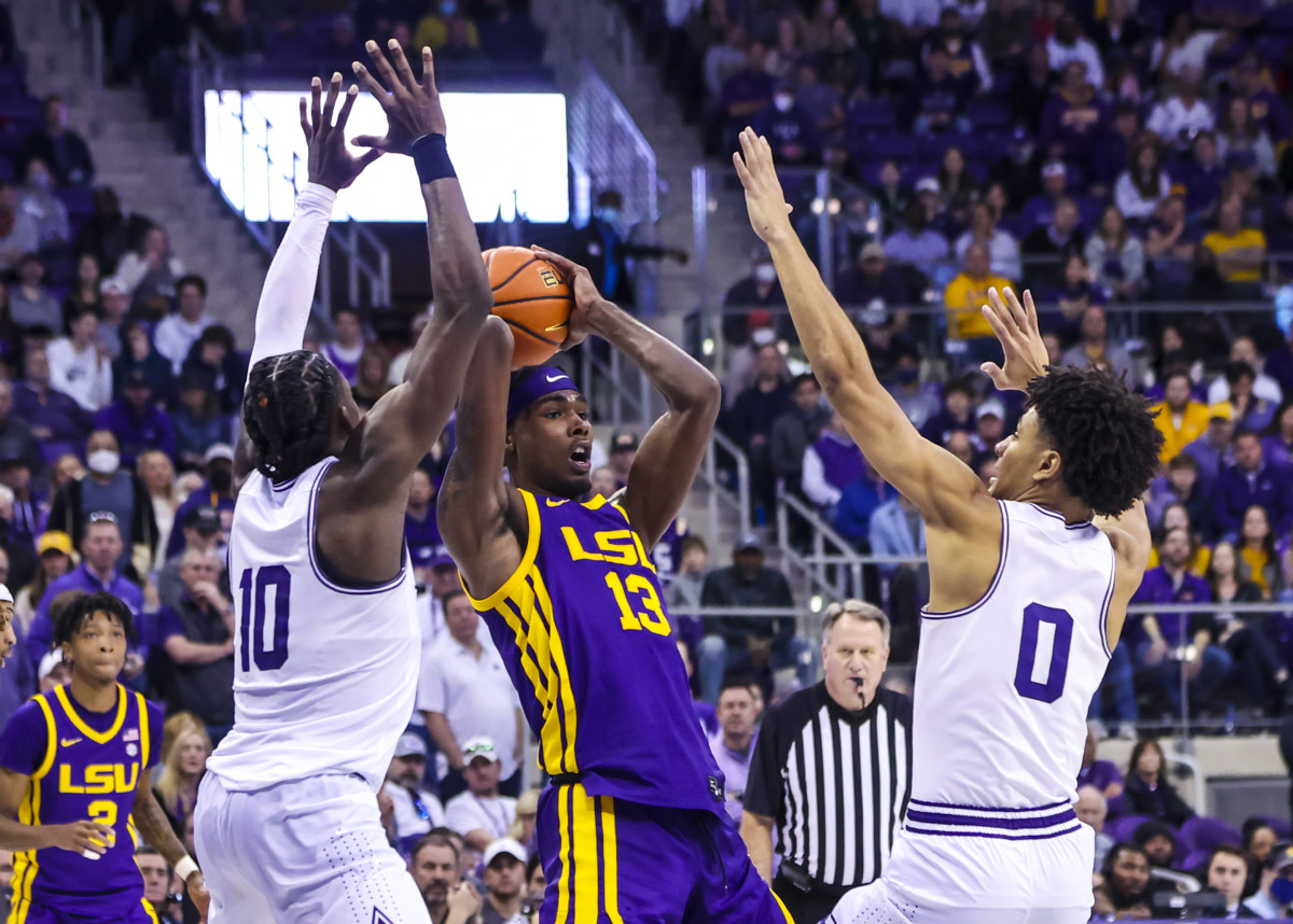Jan 29, 2022; Fort Worth, Texas, USA; LSU Tigers forward Tari Eason (13) looks to pass as TCU Horned Frogs guard Micah Peavy (0) and guard Damion Baugh (10) defend during the second half at Ed and Rae Schollmaier Arena.