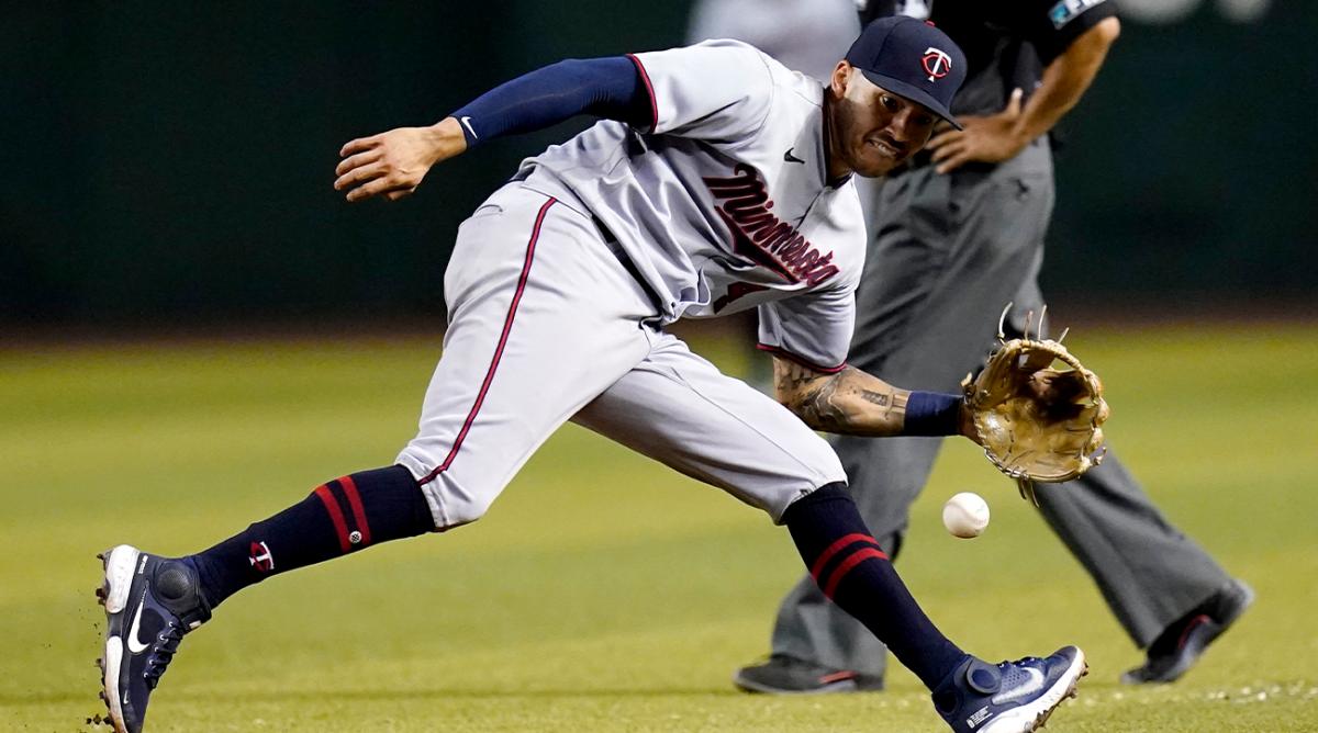 Minnesota Twins shortstop Carlos Correa, left, reaches out to make the stop on a grounder hit by Arizona Diamondbacks’ Alek Thomas, before throwing to first for the out during the ninth inning of a baseball game Saturday, June 18, 2022, in Phoenix. The Twins won 11-1.