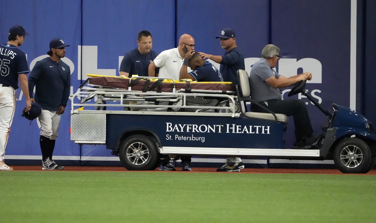 Tampa Bay Rays right fielder Manuel Margot (13) is comforted by manager Kevin Cash (16) after he was injured in the ninth inning on Monday at Tropicana Field. (Dave Nelson-USA TODAY Sports)