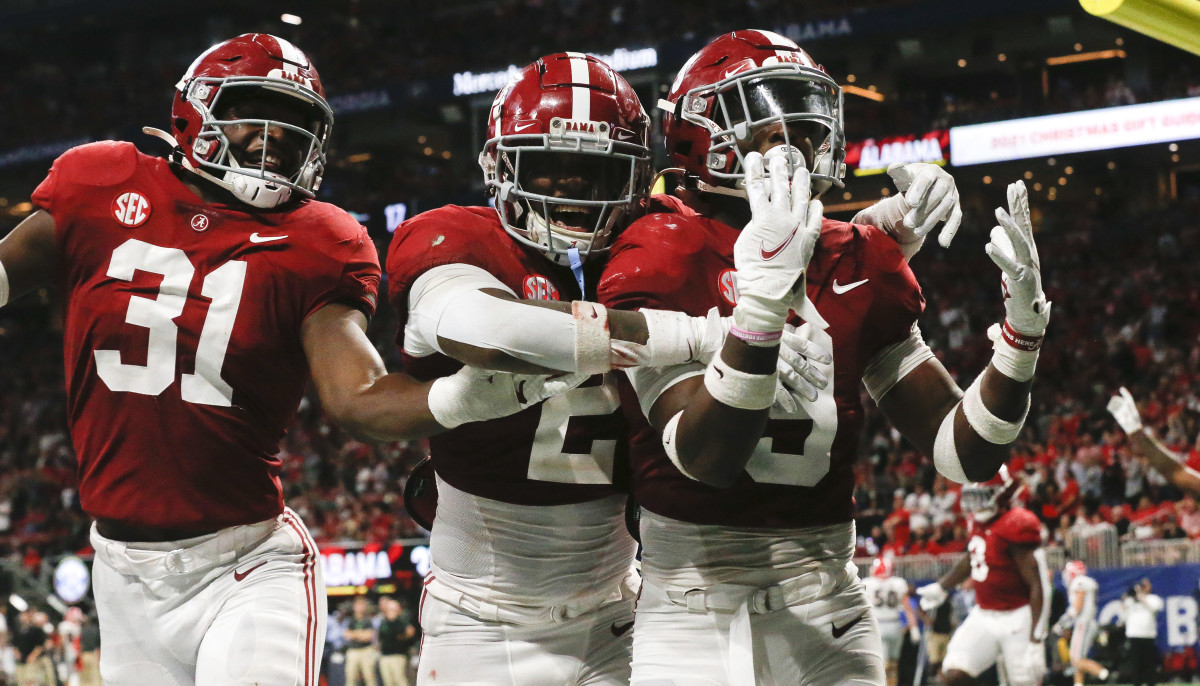 Alabama Crimson Tide linebacker Will Anderson Jr. (31) and defensive back DeMarcco Hellams (2) and defensive back Jordan Battle (9) celebrate after an interception return by Battle for a touchdown against the Georgia Bulldogs during the SEC championship game at Mercedes-Benz Stadium. Alabama won 41-24.
