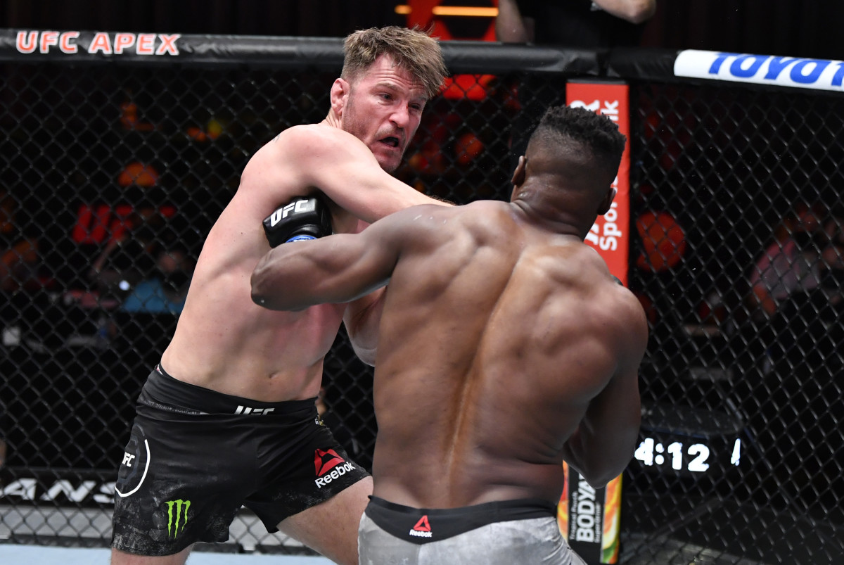 Stipe Miocic punches Francis Ngannou of Cameroon in their UFC heavyweight championship fight during the UFC 260 event at UFC APEX on March 27, 2021 in Las Vegas, Nevada.
