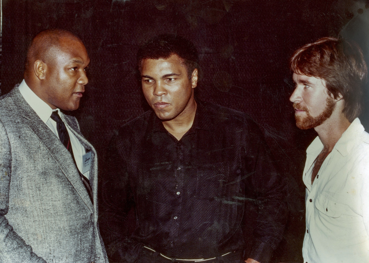 In 1994, a decade after George Foreman’s famous fight against Muhammad Ali, Smith (far right) wrote about the affair. 