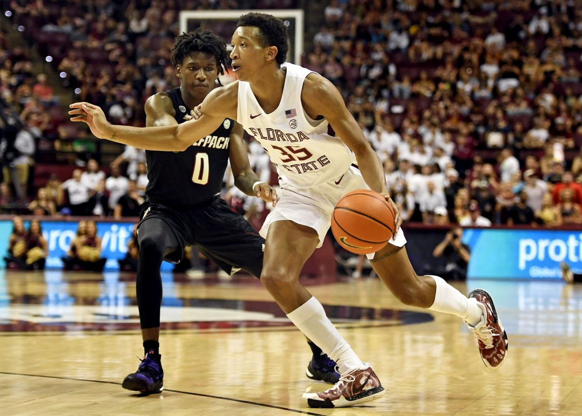 Florida State Seminoles guard Matthew Cleveland (35) drives the ball past North Carolina State Wolfpack guard Terquavion Smith (0) during the second half at Donald L. Tucker Center.