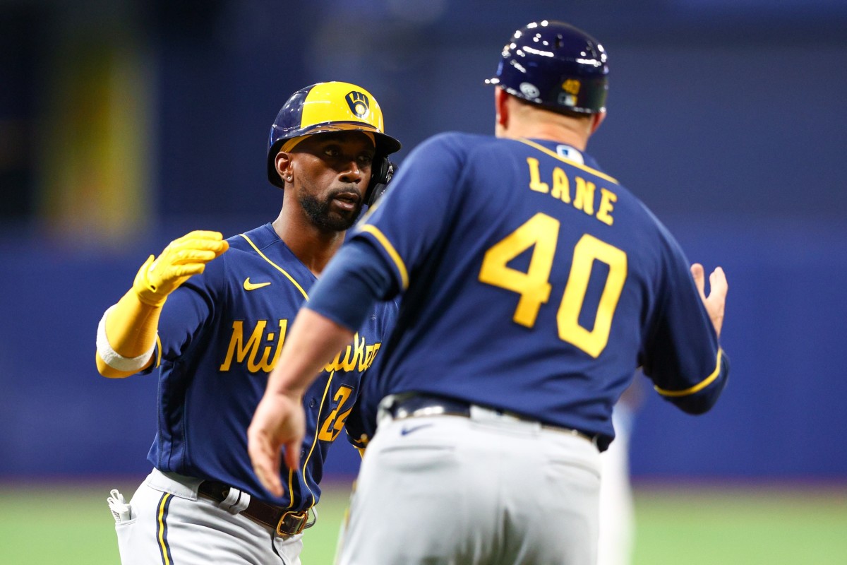 Milwaukee Brewers left fielder Andrew McCutchen (24) is congratulated by third base coach Jason Lane (40) after hitting a two-run home run against the Tampa Bay Rays in the sixth inning at Tropicana Field. (Nathan Ray Seebeck-USA TODAY Sports)