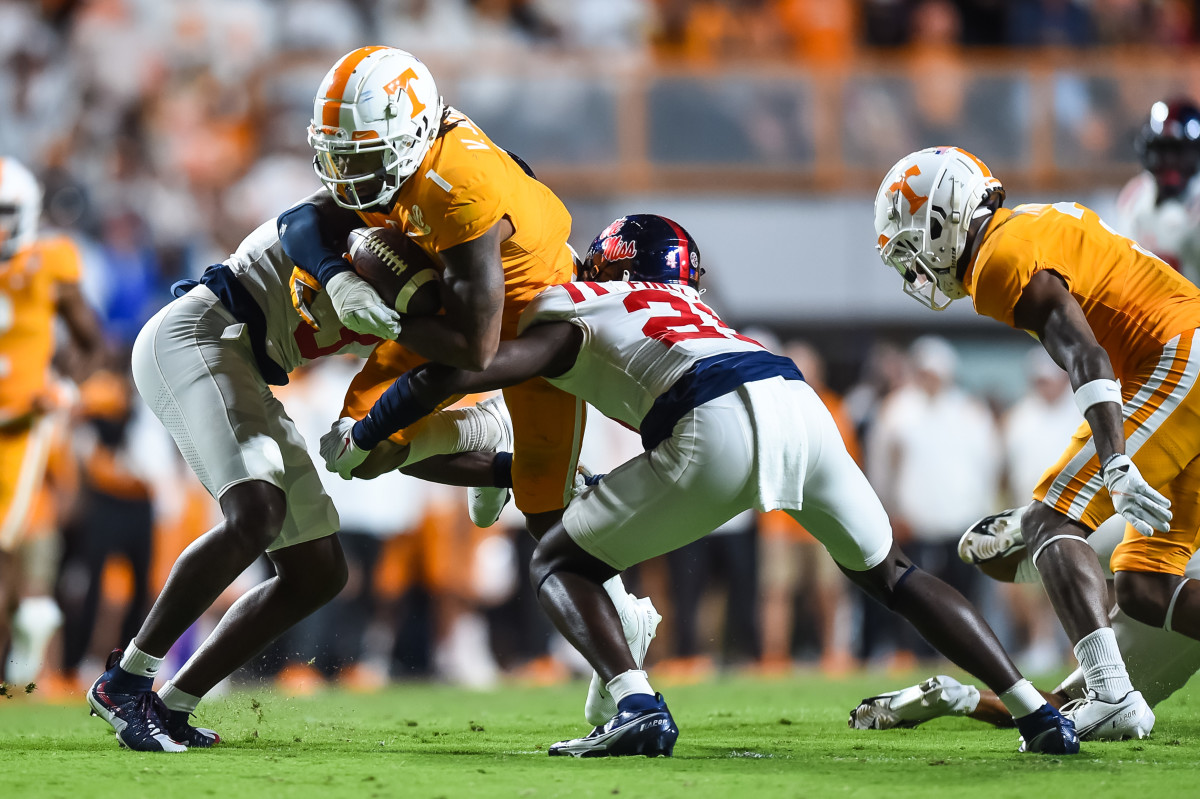 Oct 16, 2021; Knoxville, Tennessee, USA; Tennessee Volunteers wide receiver Velus Jones Jr. (1) is tackled by Mississippi Rebels defensive back Otis Reese (3) and defensive back AJ Finley (21) during the first half at Neyland Stadium. Mandatory Credit: Bryan Lynn-USA TODAY Sports