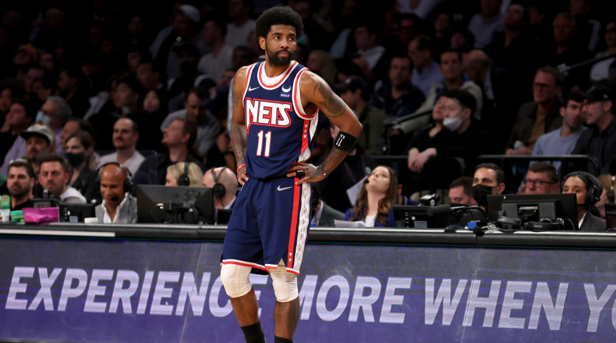 Nets guard Kyrie Irving stands on the sideline in Brooklyn.