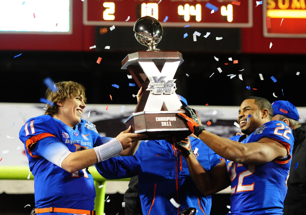 Boise State Broncos quarterback Kellen Moore (left) and running back Doug Martin celebrate with the game trophy following the game against the Arizona State Sun Devils during the 2011 Las Vegas Bowl at Sam Boyd Stadium. Boise State defeated Arizona State 56-24.