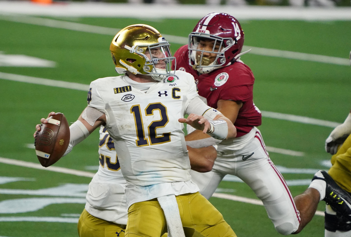 Notre Dame Fighting Irish quarterback Ian Book (12) throws against the Alabama Crimson Tide in the fourth quarter during the Rose Bowl at AT&T Stadium.