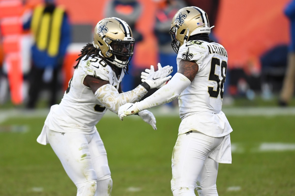 Nov 29, 2020; New Orleans Saints linebackers Demario Davis (56) and Kwon Alexander (58) celebrate a play against the Denver Broncos. Mandatory Credit: Ron Chenoy-USA TODAY Sports