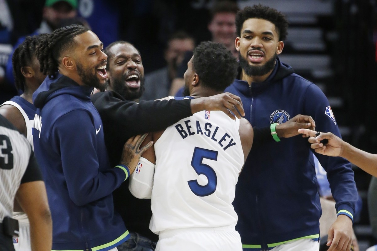 Minnesota Timberwolves guard Anthony Edwards (1) and guard Patrick Beverley (22) and center Karl-Anthony Towns (32) celebrate the three point success of guard Malik Beasley (5) against Oklahoma City Thunder at Target Center.