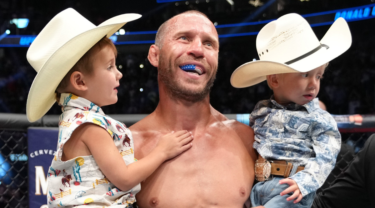 Donald Cerrone and sons in the Octagon during the UFC 276 event at T-Mobile Arena on July 02, 2022 in Las Vegas, Nevada.