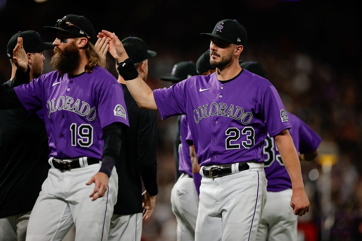 Jul 2, 2022; Denver, Colorado, USA; Colorado Rockies designated hitter Charlie Blackmon (19) and left fielder Kris Bryant (23) celebrate with teammates after the game against the Arizona Diamondbacks at Coors Field. Mandatory Credit: Isaiah J. Downing-USA TODAY Sports