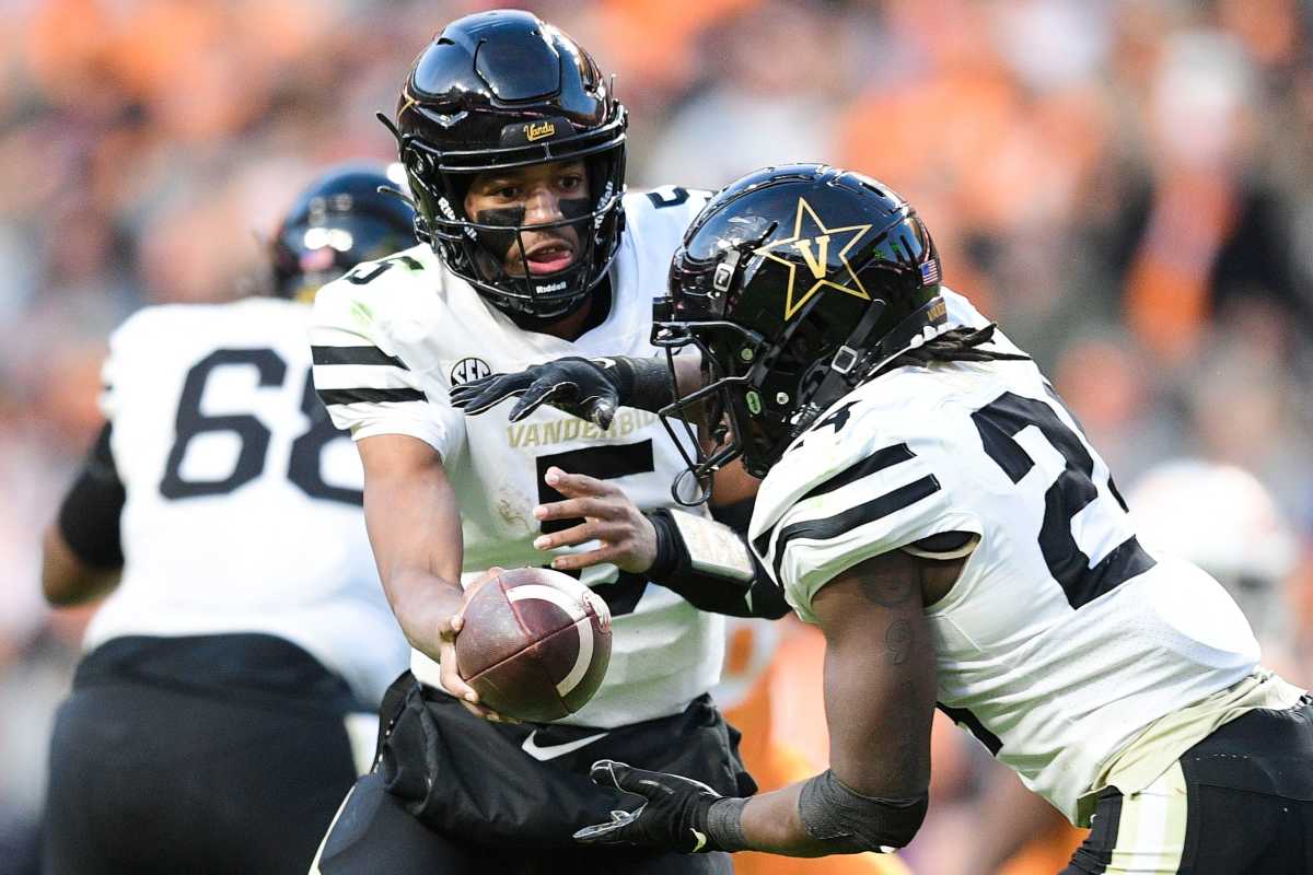 Vanderbilt quarterback Mike Wright (5) hands the ball off to Vanderbilt running back Rocko Griffin (24) during an SEC conference with Tennessee at Neyland Stadium in Knoxville, Tenn. on Saturday, Nov. 27, 2021.