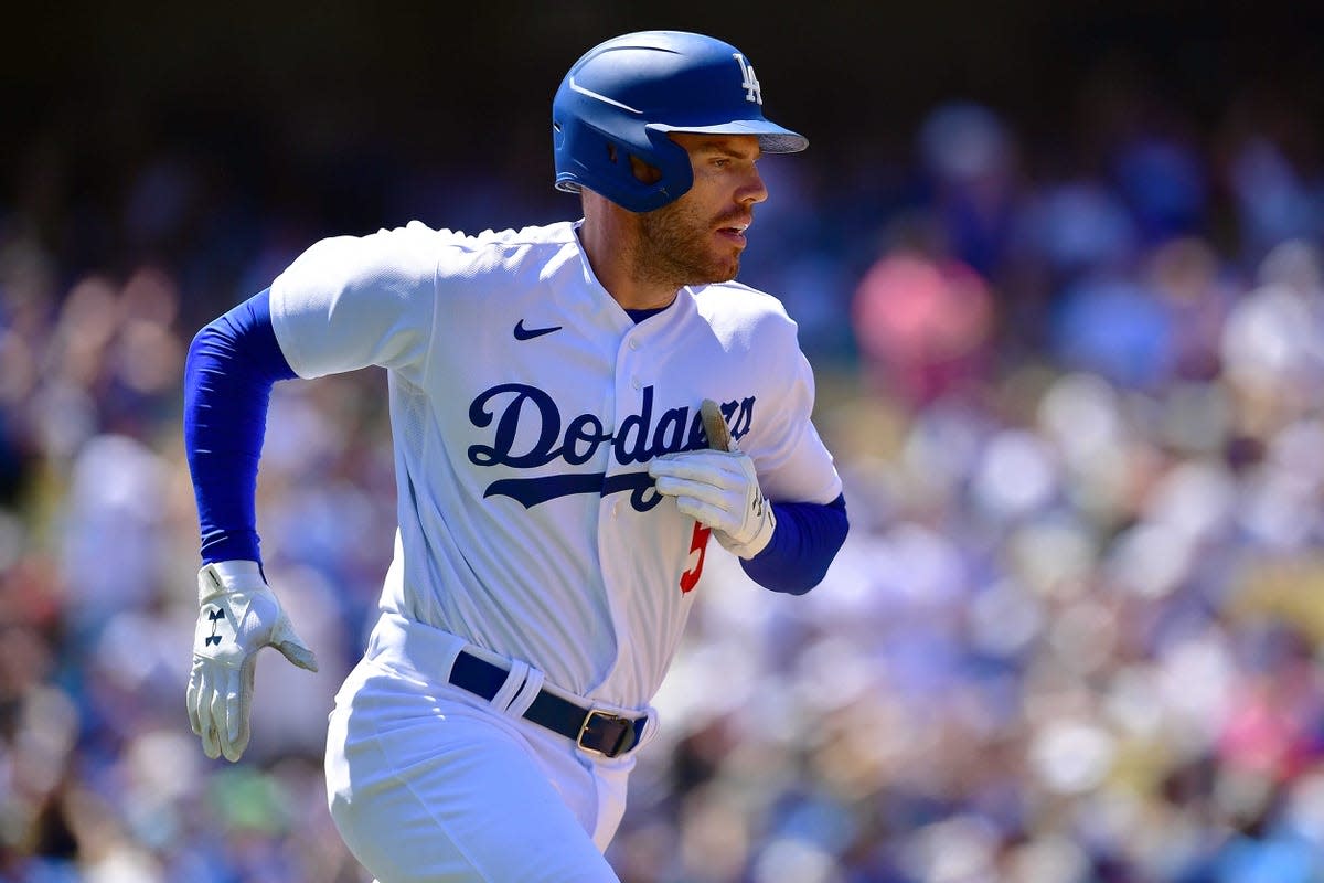 Jul 3, 2022; Los Angeles, California, USA; Los Angeles Dodgers first baseman Freddie Freeman (5) runs after hitting a single against the San Diego Padres during the fourth inning at Dodger Stadium. Mandatory Credit: Gary A. Vasquez-USA TODAY Sports