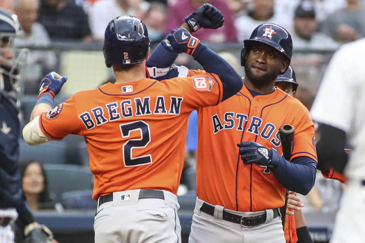 Houston Astros left fielder Yordan Álvarez celebrates with teammate Alex Bregman.