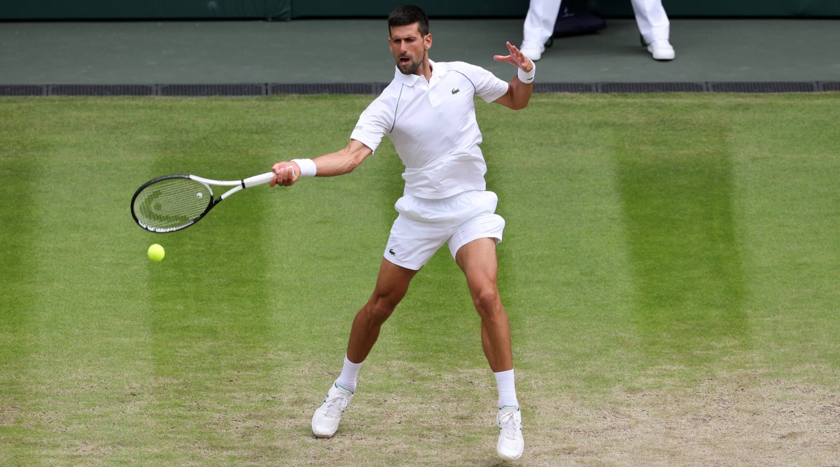 Novak Djokovic hits a forehand during a quarterfinal match at Wimbledon.