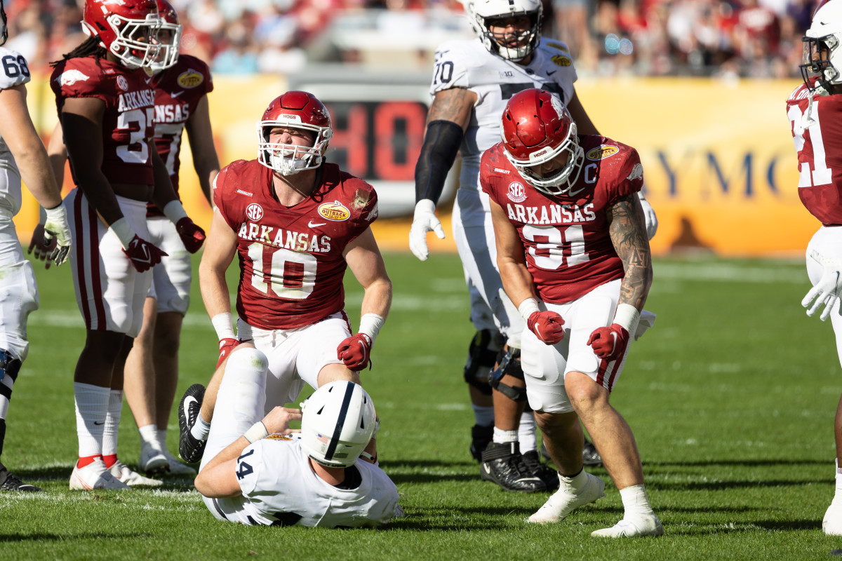 Jan 1, 2022; Tampa, FL, USA; Arkansas Razorbacks linebacker Bumper Pool (10) and linebacker Grant Morgan (31) celebrate after a sack during the second half against the Penn State Nittany Lions during the 2022 Outback Bowl at Raymond James Stadium. Mandatory Credit: Matt Pendleton-USA TODAY Sports