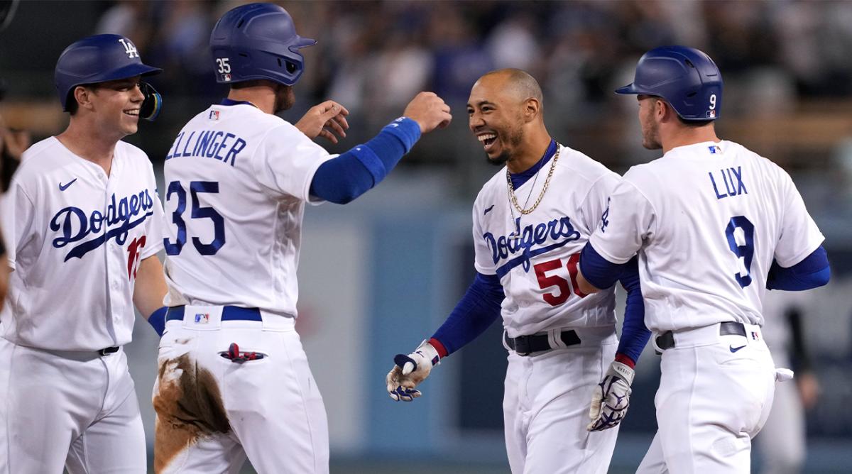 Jul 6, 2022; Los Angeles, California, USA; Los Angeles Dodgers right fielder Mookie Betts (50) celebrates with catcher Will Smith (left), center fielder Cody Bellinger (35) and left fielder Gavin Lux (9) after hitting a walk-off single against the Colorado Rockies at Dodger Stadium.