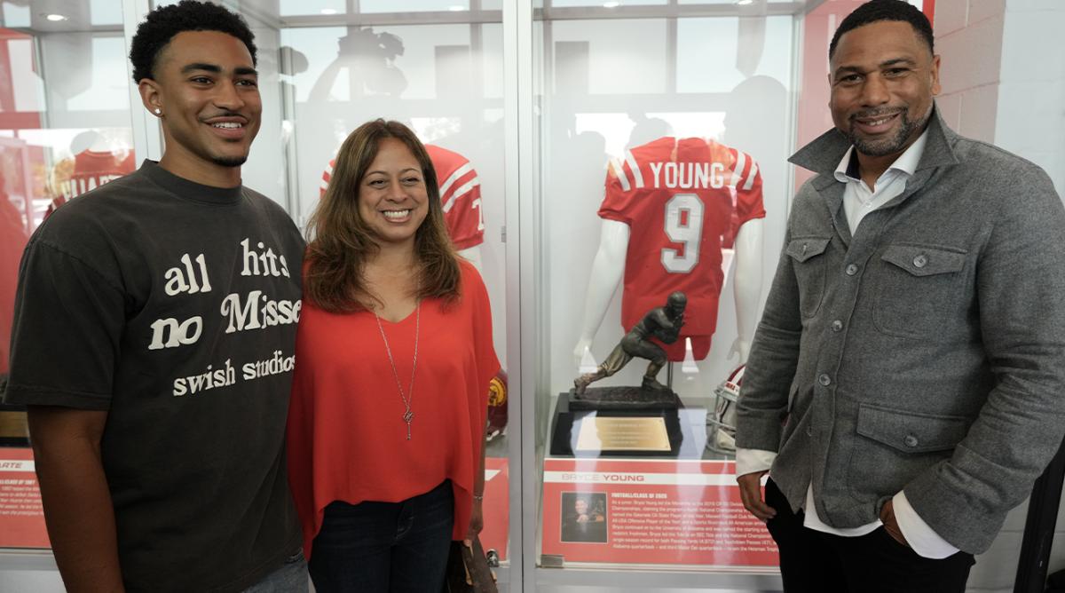 May 24, 2022; Santa Ana, California USA; Heisman Trophy winner Bryce Young of Alabama (2021), left, poses with mother Julie Young (center) and father Craig Young during the Mater Dei High Heisman Homecoming ceremony at the Meruelo Athletic Center.