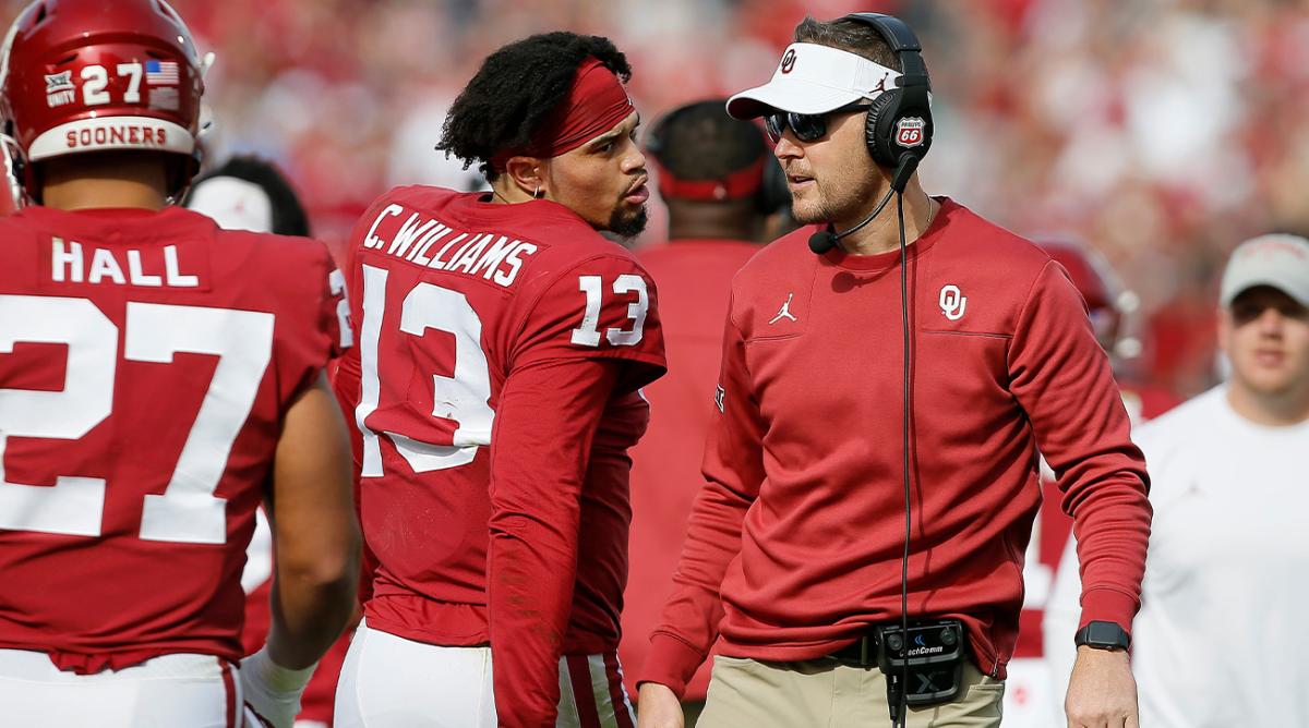 Coach Lincoln Riley talks with Caleb Williams (13) during the Sooners’ 28-21 win against Iowa State on Nov. 20. They are now reunited at USC.