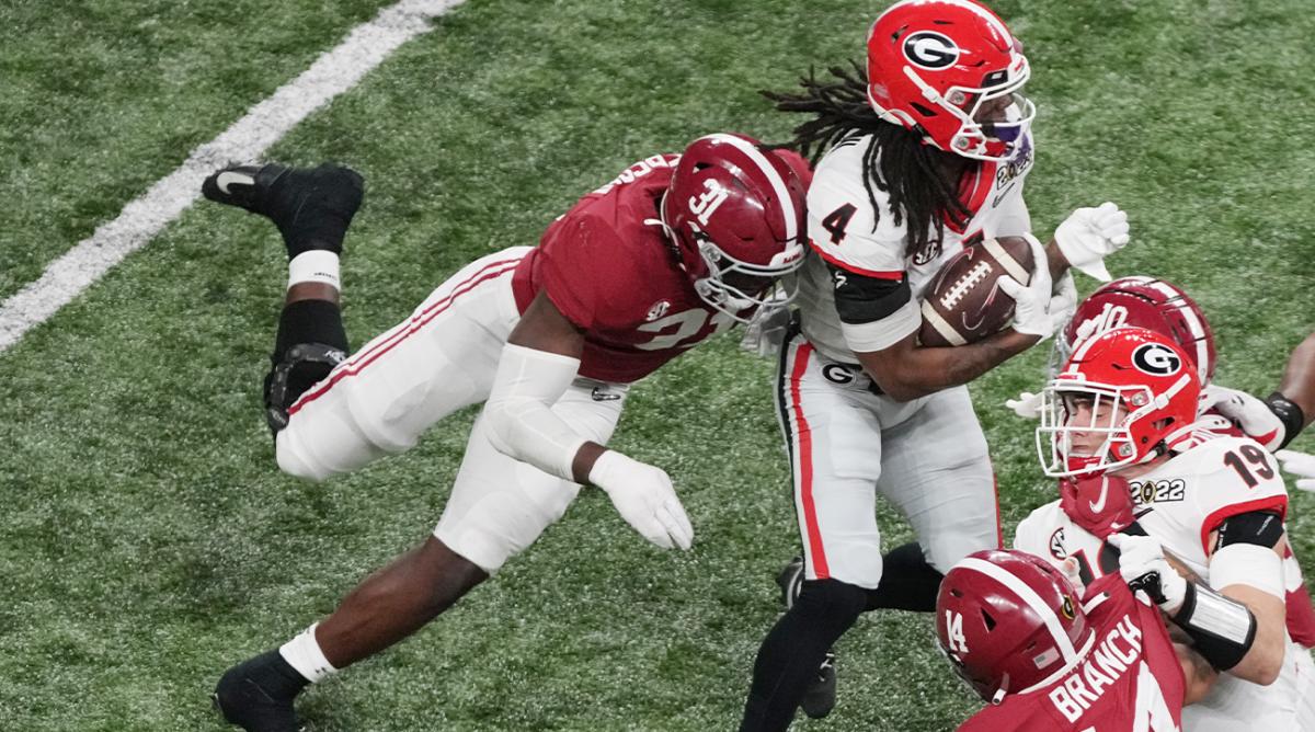 Jan 10, 2022; Indianapolis, IN, USA; Georgia Bulldogs running back James Cook (4) is tackled by Alabama Crimson Tide linebacker Will Anderson Jr. (31) in the second quarter during the 2022 CFP college football national championship game at Lucas Oil Stadium.