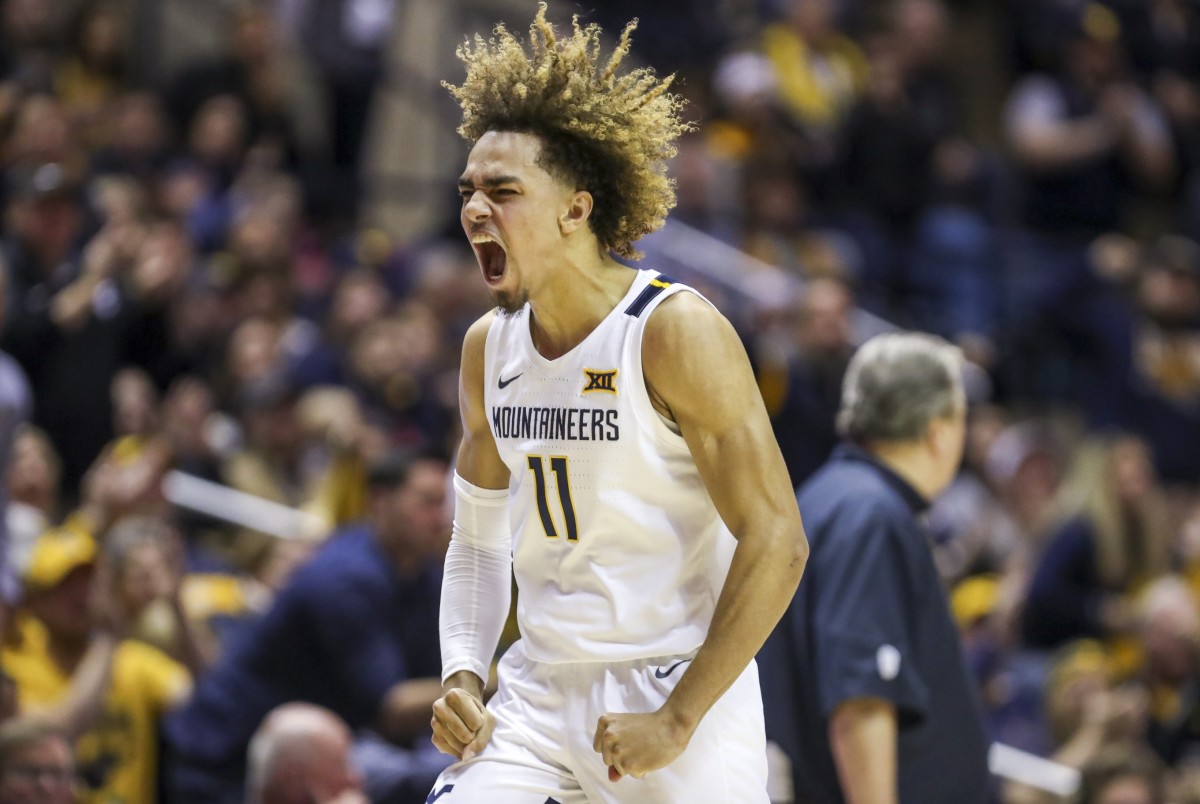 Feb 29, 2020; Morgantown, West Virginia, USA; West Virginia Mountaineers forward Emmitt Matthews Jr. (11) celebrates after a play during the second half against the Oklahoma Sooners at WVU Coliseum.