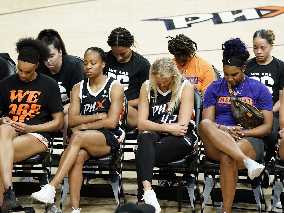 Mercury players bow their heads in prayer at a rally for WNBA basketball teammate Brittney Griner.