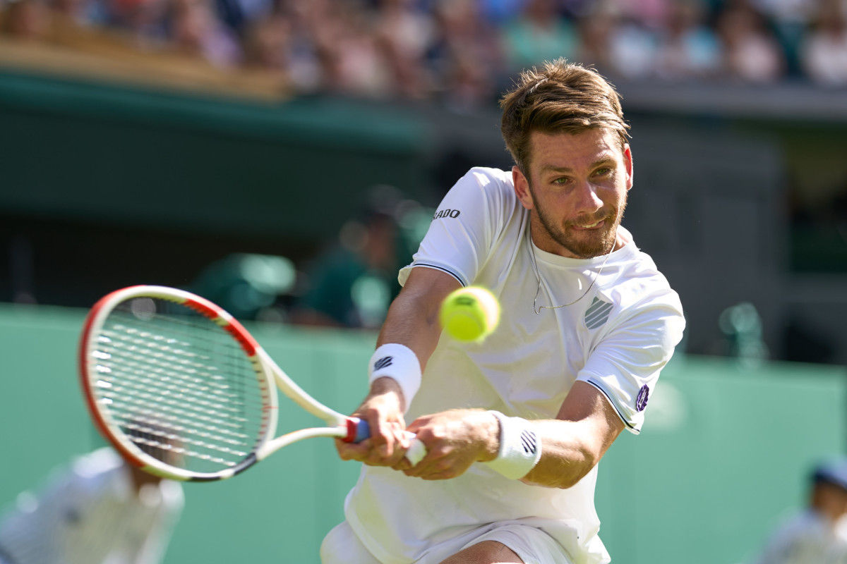 Jul 8, 2022; London, England, United Kingdom; Cameron Norrie (GBR) returns a shot in his semi finals men s singles match against Novak Djokovic (SRB) on Centre court at All England Lawn Tennis and Croquet Club.