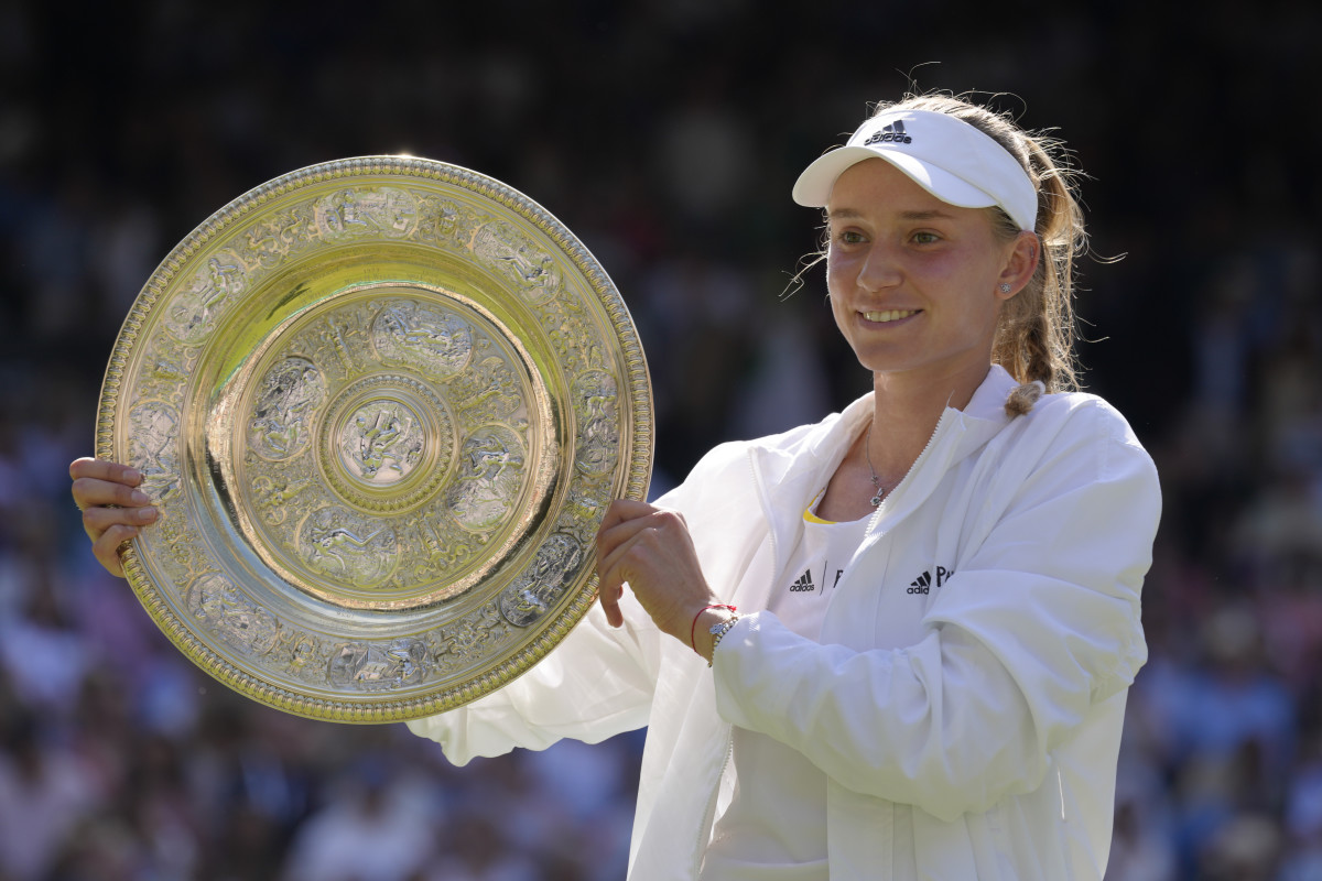 Elena Rybakina hoists the trophy at Wimbledon