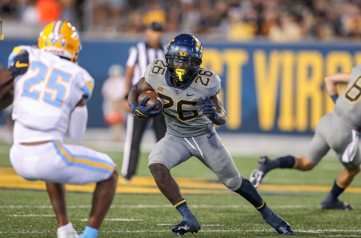 Sep 11, 2021; Morgantown, West Virginia, USA; West Virginia Mountaineers running back Justin Johnson Jr. (26) runs the ball during the fourth quarter against the Long Island Sharks at Mountaineer Field at Milan Puskar Stadium.