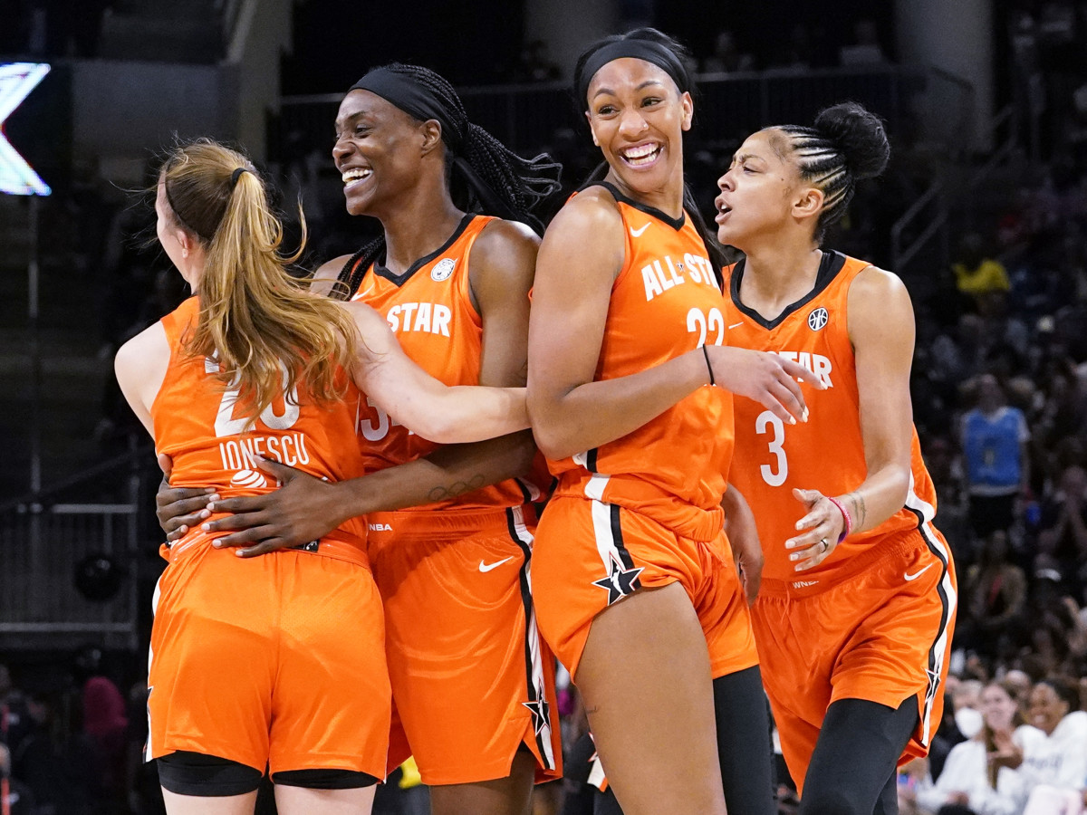 Sylvia Fowle celebrates with teammates after dunking during the first half of the WNBA All-Star Game.