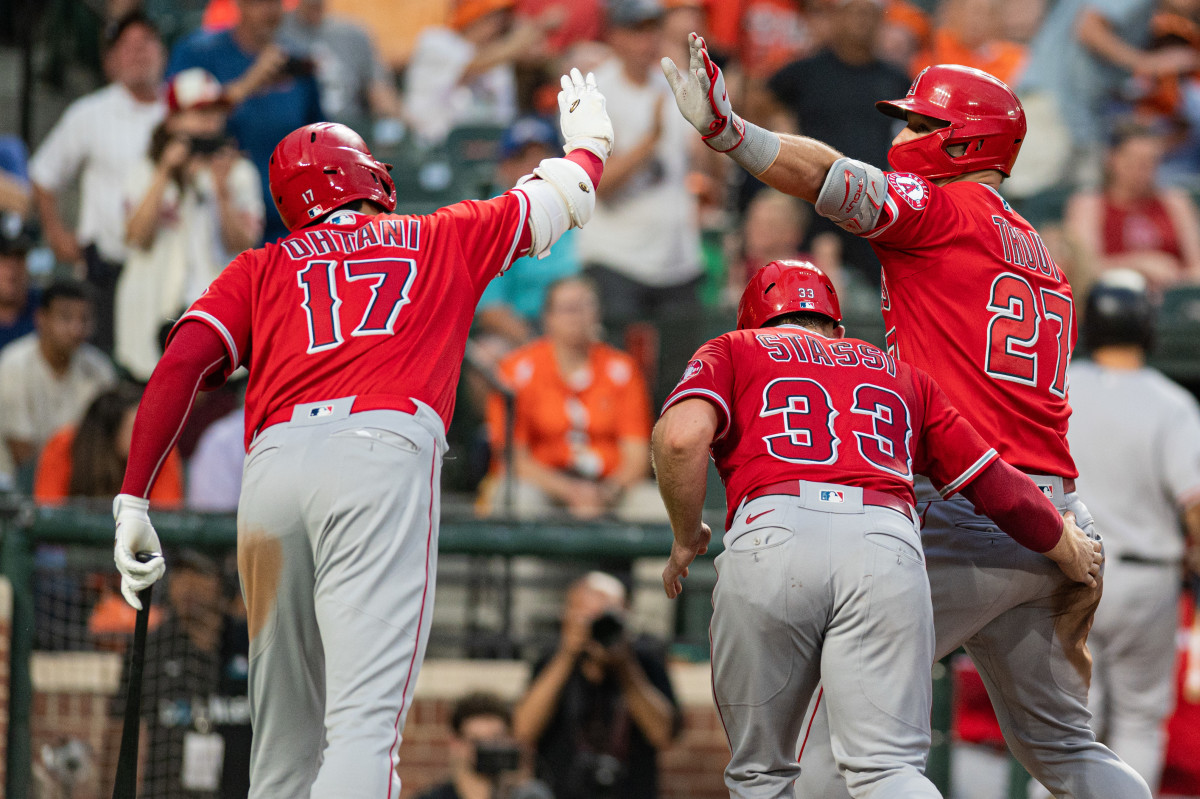 Shohei Ohtani celebrates with Mike Trout after Trout hit a home run against the Baltimore Orioles.