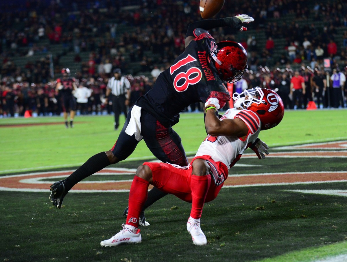 Sep 18, 2021; Carson, California, USA; San Diego State Aztecs safety Trenton Thompson (18) defends against Utah Utes wide receiver Jaylen Dixon (25) during overtime at Dignity Health Sports Park.
