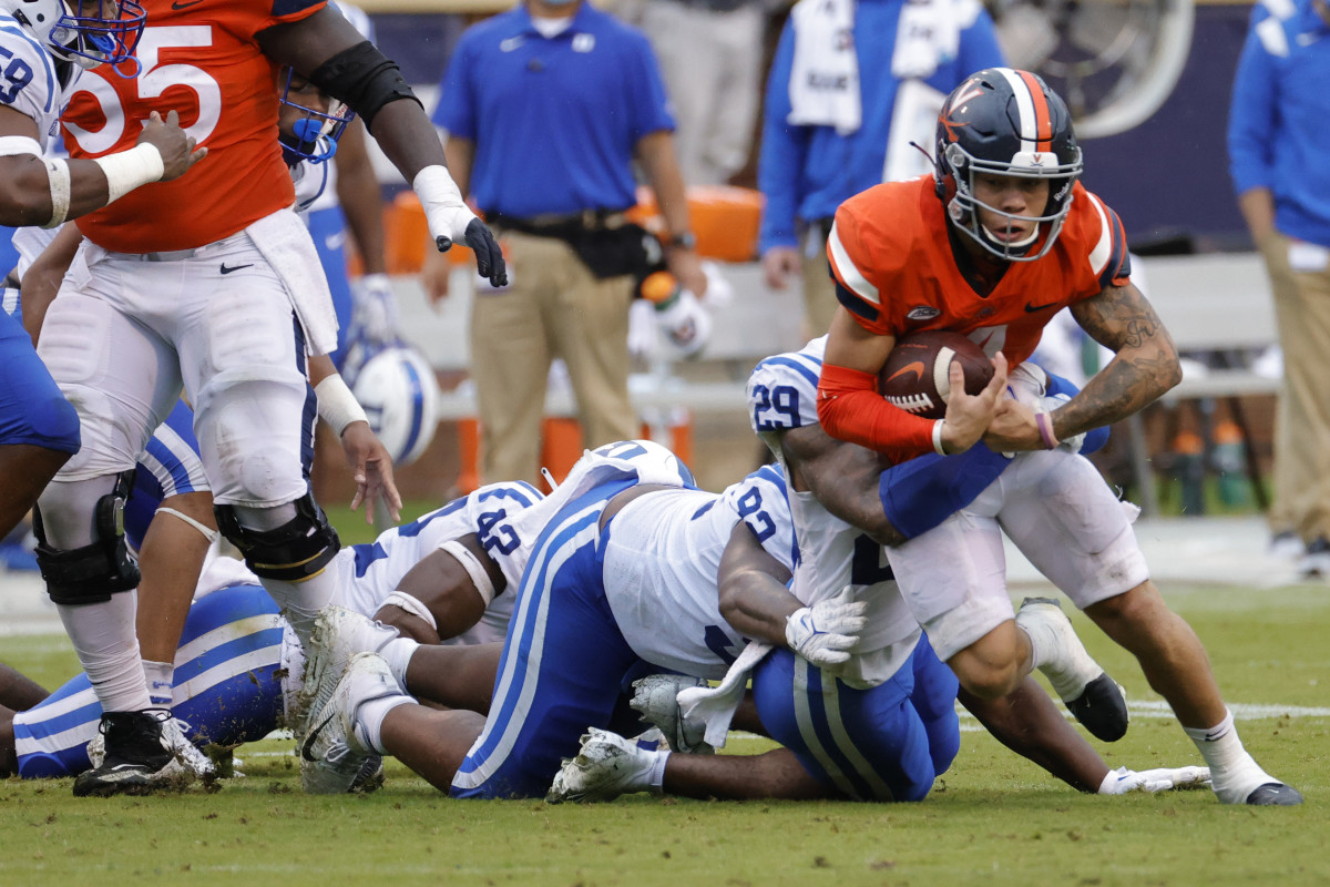 Virginia Cavaliers wide receiver Billy Kemp IV (4) is tackled while carrying the ball by Duke Blue Devils safety Nate Thompson (29) during the second quarter at Scott Stadium.