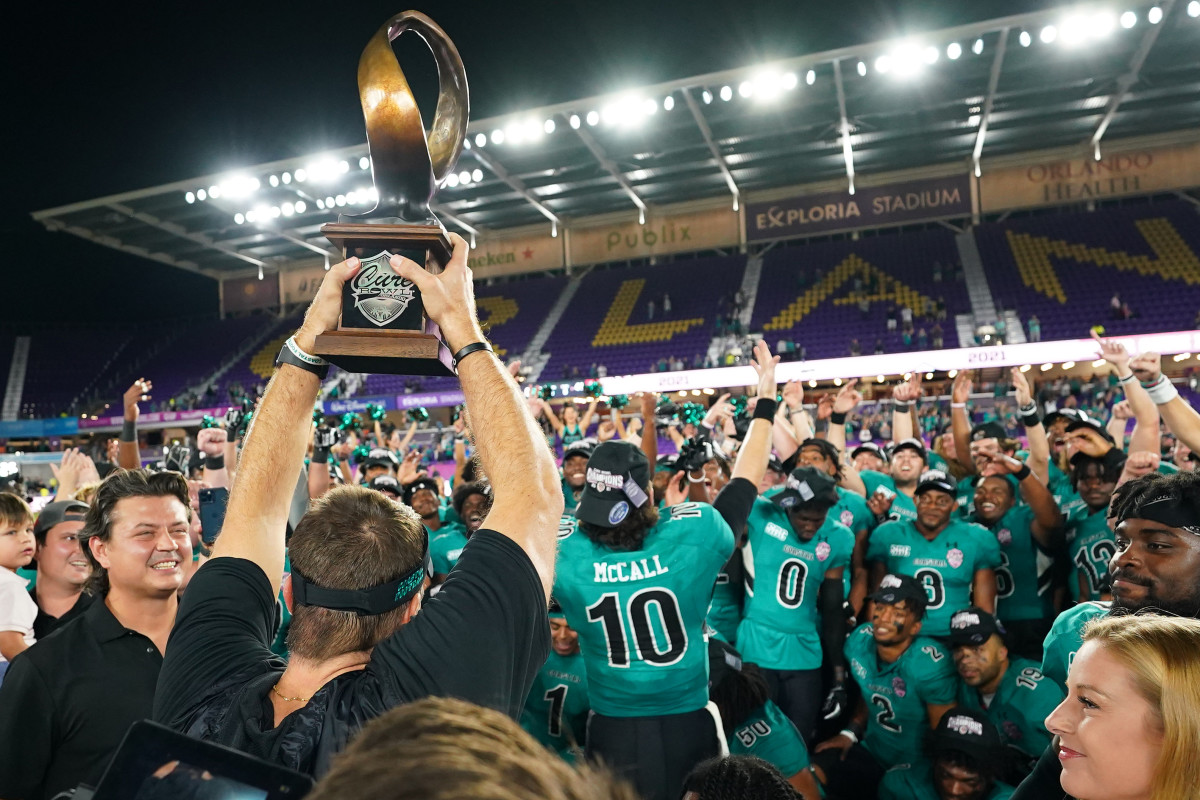 Coastal Carolina Chanticleers head coach Jamey Chadwell lifts the trophy in celebration with his team after defeating the Northern Illinois Huskies during in the 2021 Cure Bowl game at Exploria Stadium.