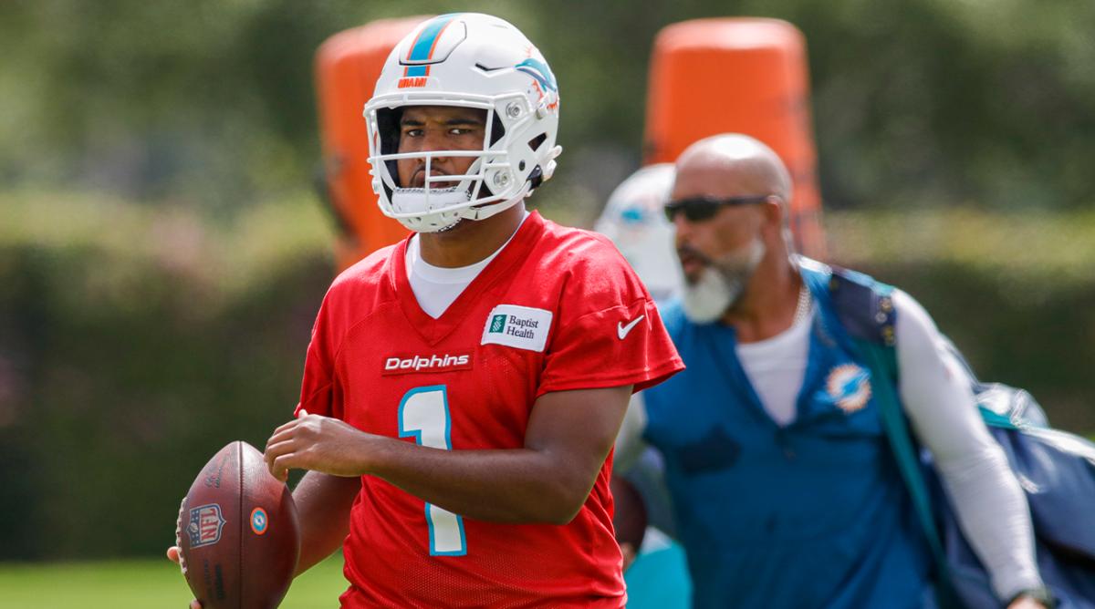 Jun 2, 2022; Miami Gardens, Florida, USA; Miami Dolphins quarterback Tua Tagovailoa (1) walks on field with a football during minicamp at Baptist Health Training Complex.