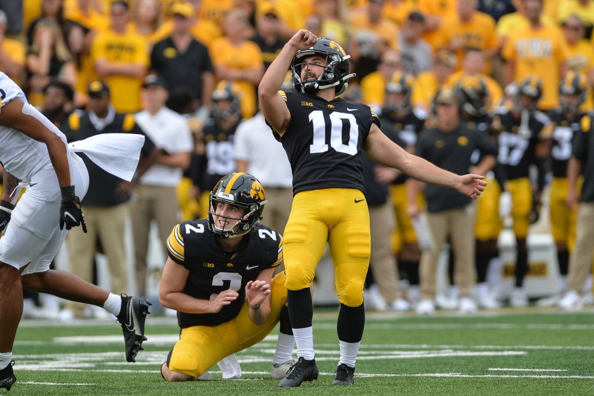 Iowa Hawkeyes place kicker Caleb Shudak (10) and punter Ryan Gersonde (2) in action against the Penn State Nittany Lions at Kinnick Stadium.