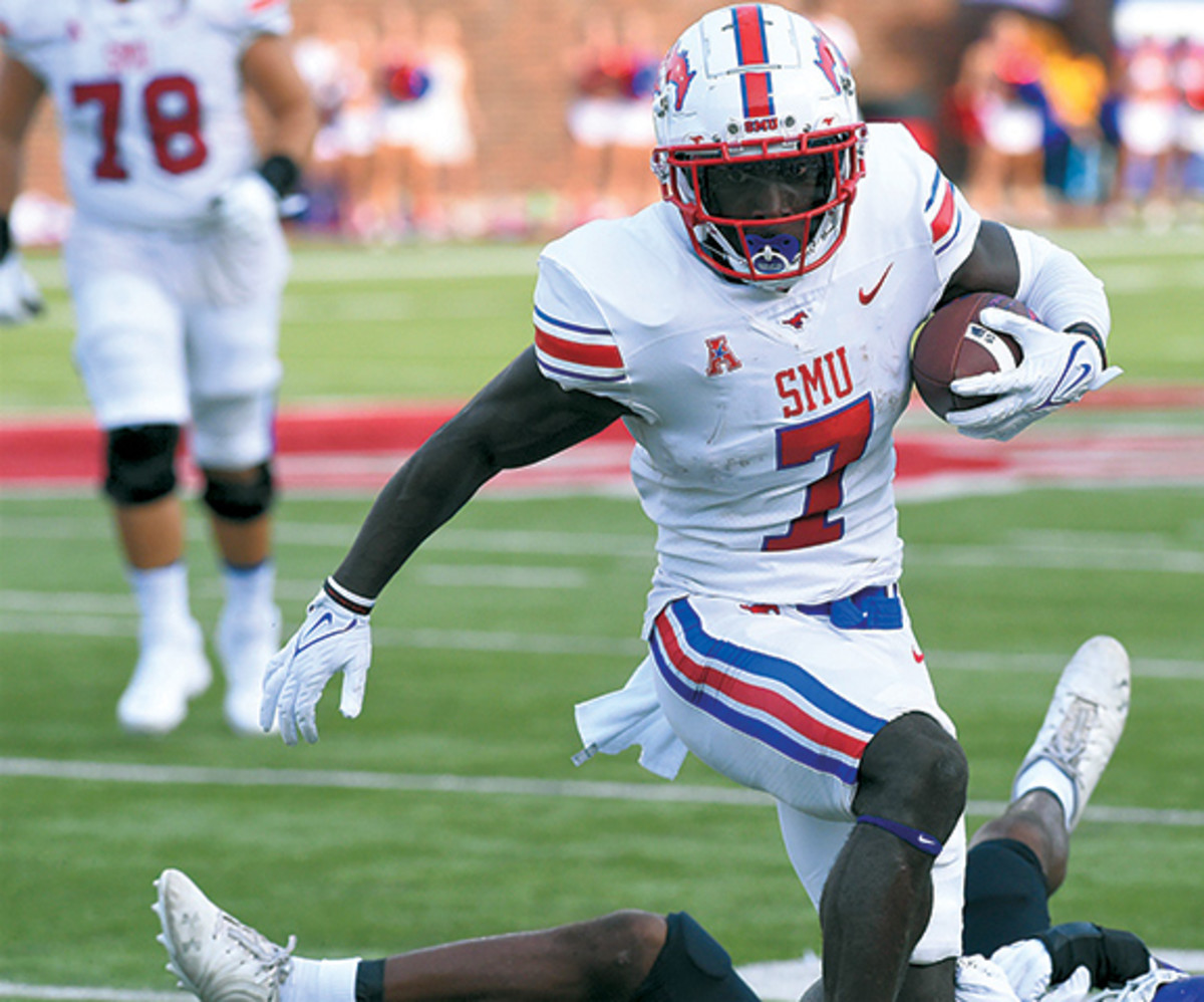 SMU running back Ulysses Bentley IV (7) tries to go over an ACU defender during Saturday's game at Gerald J. Ford Stadium in Dallas on Sept. 4, 2021. The Mustangs won 56-9.