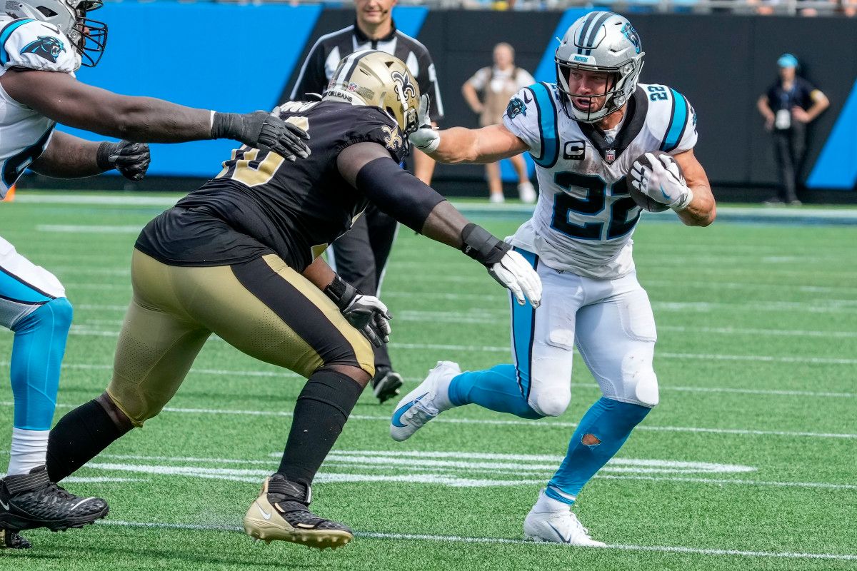 Carolina Panthers running back Christian McCaffrey (22) pushes off a New Orleans Saints defender during the second half at Bank of America Stadium.