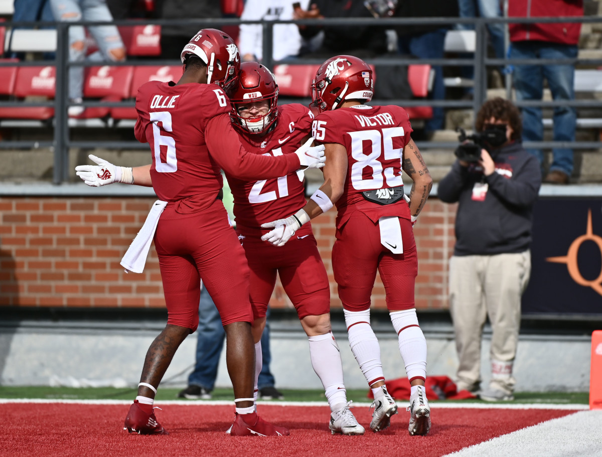 Washington State Cougars running back Max Borghi (21) celebrates a score with teammates Washington State Cougars wide receiver Donovan Ollie (6) and Washington State Cougars wide receiver Lincoln Victor (85) during a game against the Brigham Young Cougars in the first half at Gesa Field at Martin Stadium.Washington State Cougars running back Max Borghi (21) celebrates a score with teammates Washington State Cougars wide receiver Donovan Ollie (6) and Washington State Cougars wide receiver Lincoln Victor (85) during a game against the Brigham Young Cougars in the first half at Gesa Field at Martin Stadium.